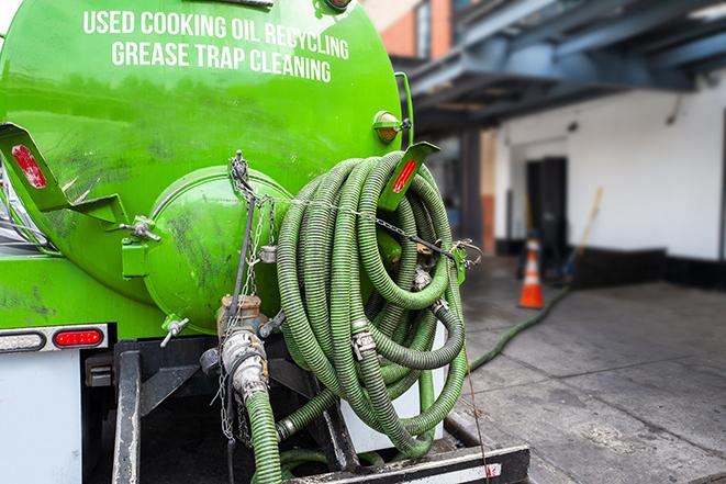 a grease trap being pumped by a sanitation technician in Gig Harbor, WA